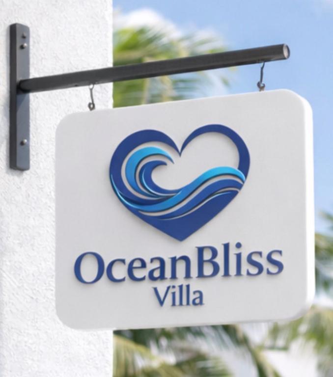 a sign for an ocean bliss villa on a building at Oceanbliss Villa in Pallipuram