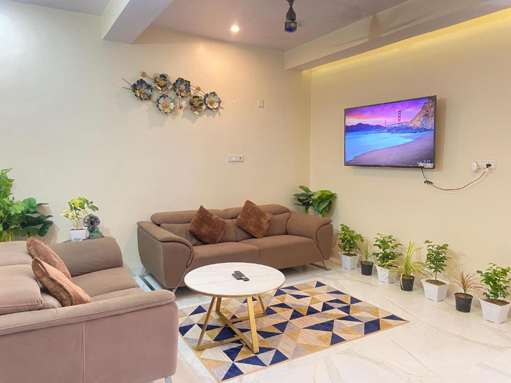 a living room with two couches and a table at Vedavit Bhavanam in Gaya