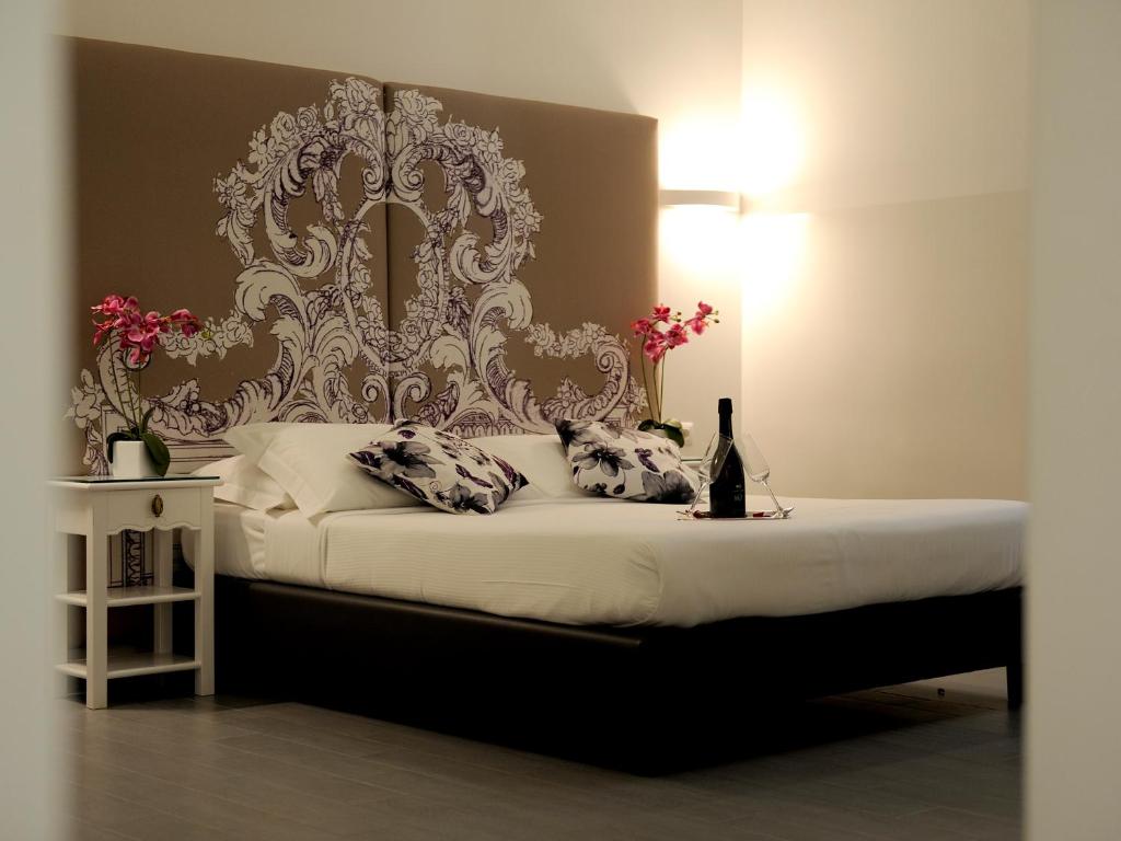 a bedroom with a bed with a large headboard at Easyrome Guest House in Rome