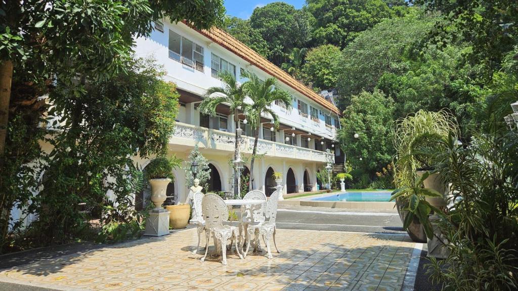 a table and chairs in front of a building at Hotel Bella Monte in Olongapo