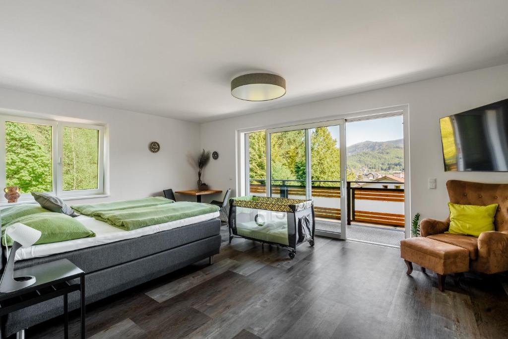 a bedroom with a large bed and a balcony at Seeblick Homes in Fuschl am See