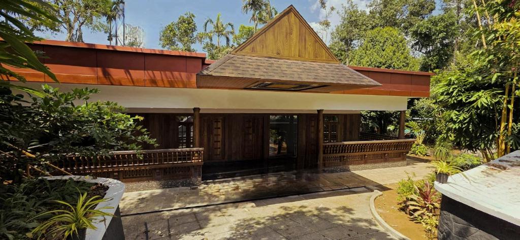 a small house with a roof on top of it at Ourea's Rest in Thekkady