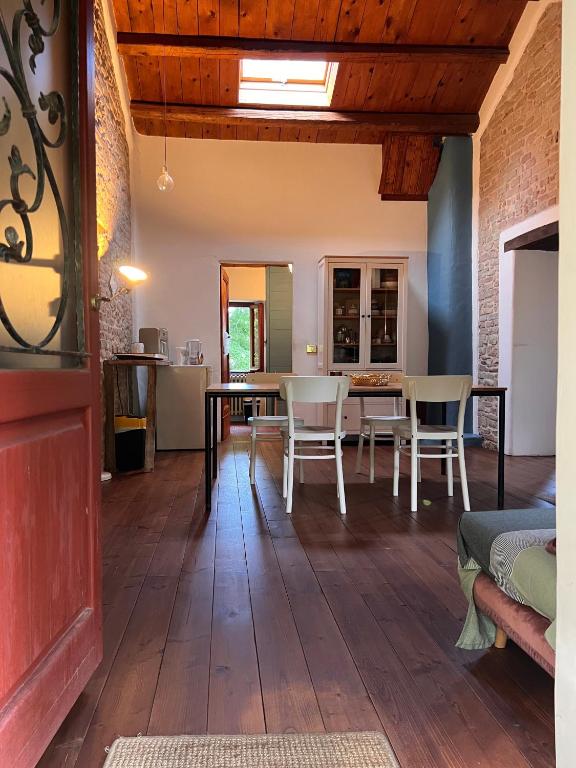 a kitchen and dining room with a table and chairs at The Bookhouse Home Bb in Poggio San Marcello 