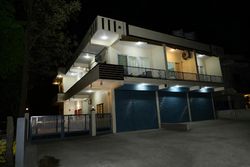 a large house at night with its lights on at Coorg Manam Homestay in Kushālnagar