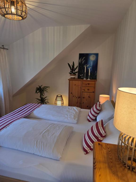 a bedroom with two white beds and a dresser at Kiek mol rin - Richmanns Appartements in Hüde