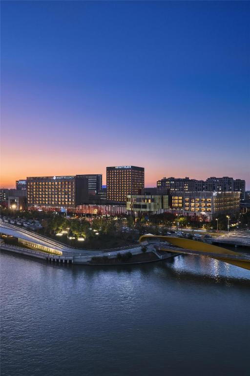 a view of a city with a bridge over the water at Hyatt Regency Shanghai Pudong Lingang in Zhenghai