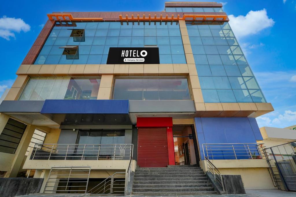 a building with a mittelco sign on it at Hotel O Chikkabanavara Lakeview Bangalore Formerly Bvk Residency in Bangalore