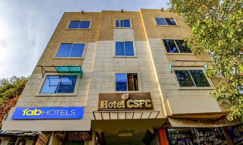 a tall building with a hotel osco sign on it at FabHotel CSFC in Bhopal