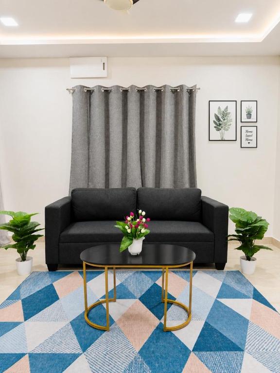 a living room with a couch and a table at SV Serenity Homestays in Gachibowli