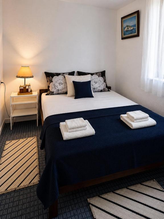 a bedroom with a large bed with towels on it at Veles House in Herceg-Novi