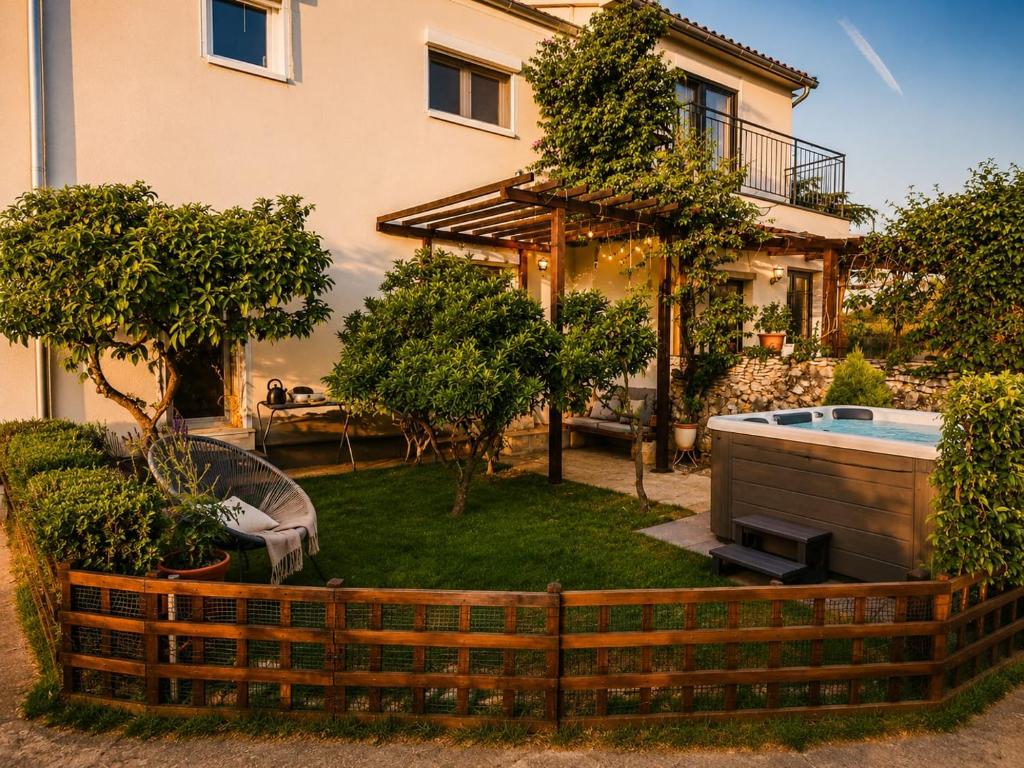 a backyard with a pool and a house at Family nest Medulin- apartment with private parking and jacuzzi in Medulin