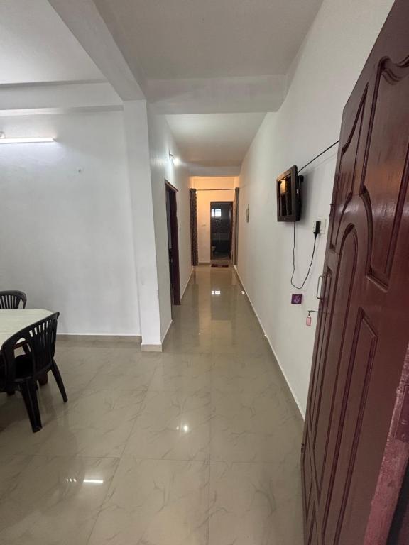 a hallway of a room with a table and a chair at Kuttikkanam stay in Pīrmed