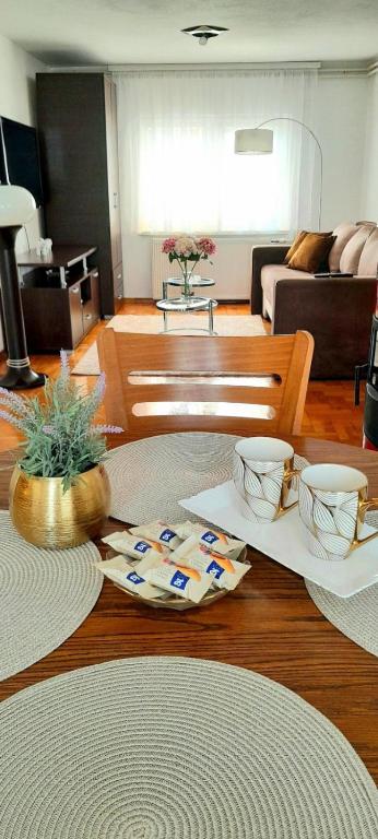 a living room with a table with two bowls on it at Apartman Layla in Bihać
