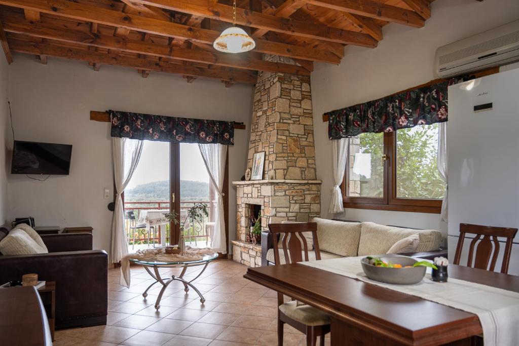 a living room with a table and a fireplace at House Demetra in Astris