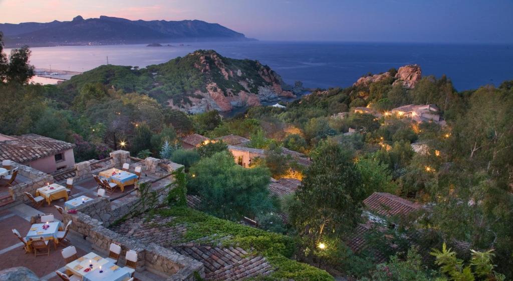 an aerial view of a village on a hill with the ocean at Hotel Monte Turri - Adults Only in Àrbatax