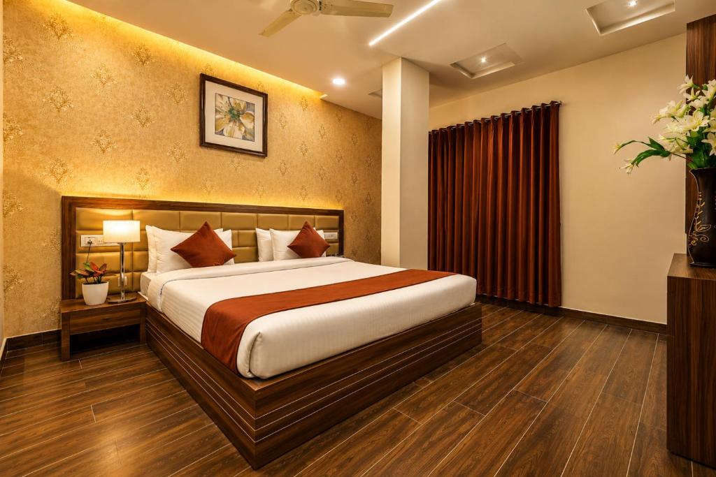 a bedroom with a bed in a room at Hotel Shiv Shakti in Rajkot