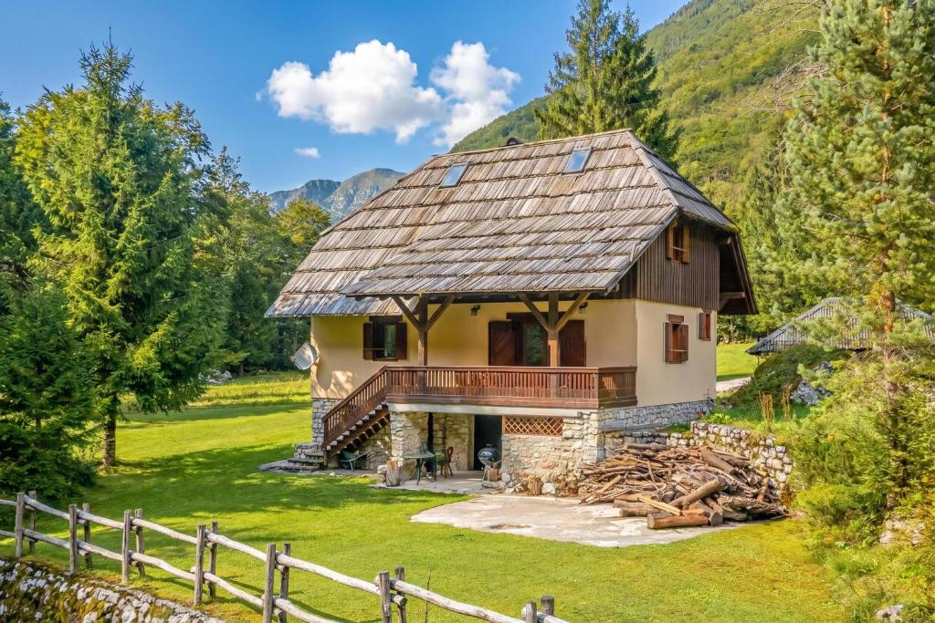 ein Haus in den Bergen mit einem Zaun in der Unterkunft Chalet Primus in Soča Valley - Happy Rentals in Soča