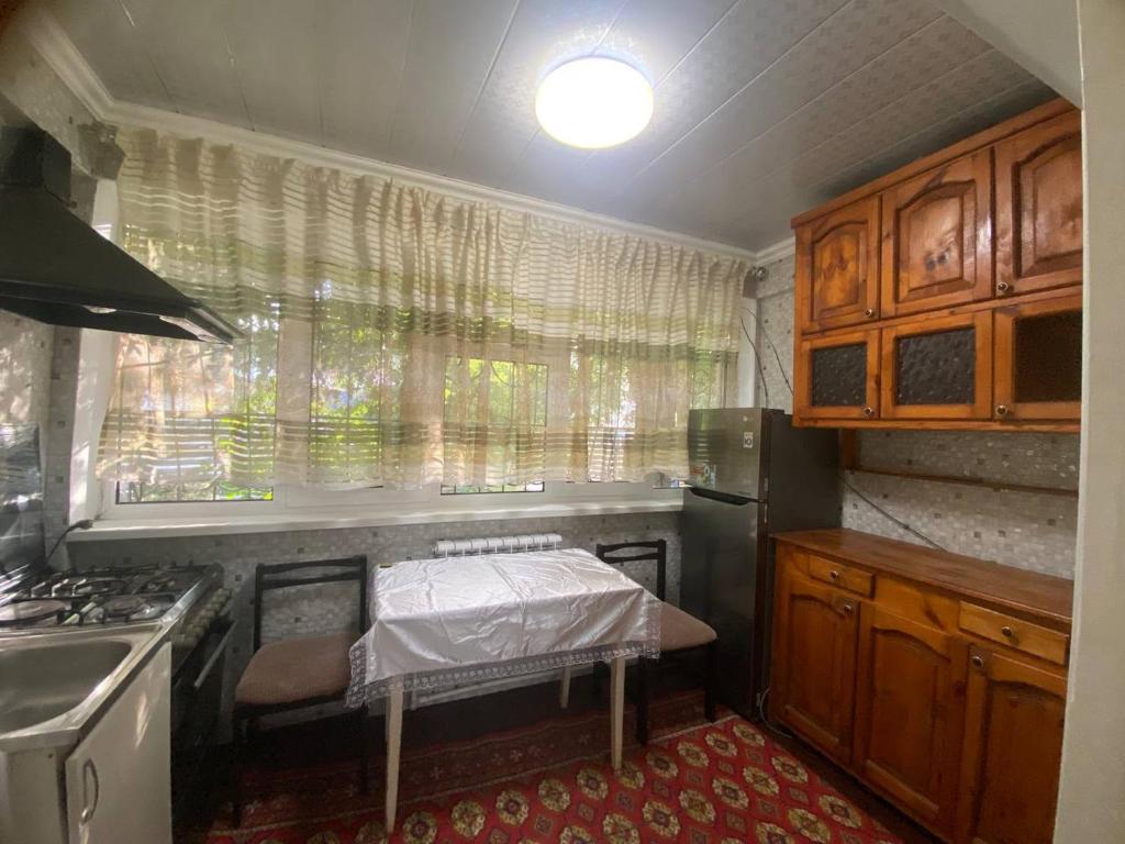 a small kitchen with a bed and a window at Samarkand,Uzbekistan in Samarkand