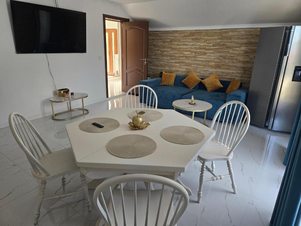 a living room with a table and chairs and a couch at Casa Roberto in Budeşti