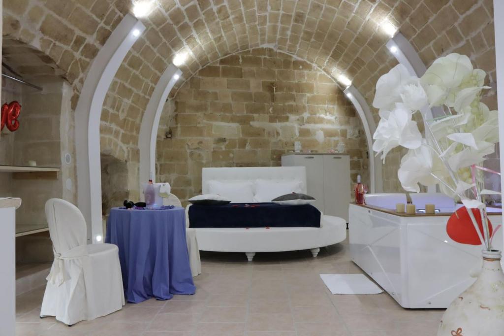 a bedroom with a bed and a table in a room at Relax Santa Cecilia in Gravina in Puglia