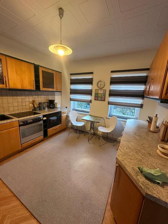 a kitchen with a table and chairs in a room at Relax in the Harz in Hasselfelde