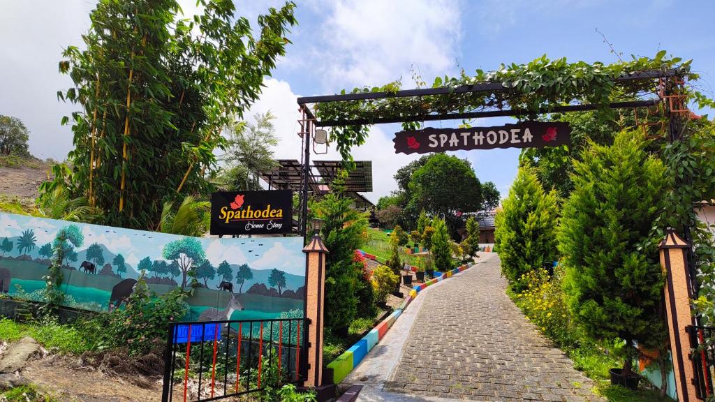a garden path with a sign that reads shambhar at SPATHODEA in Vagamon