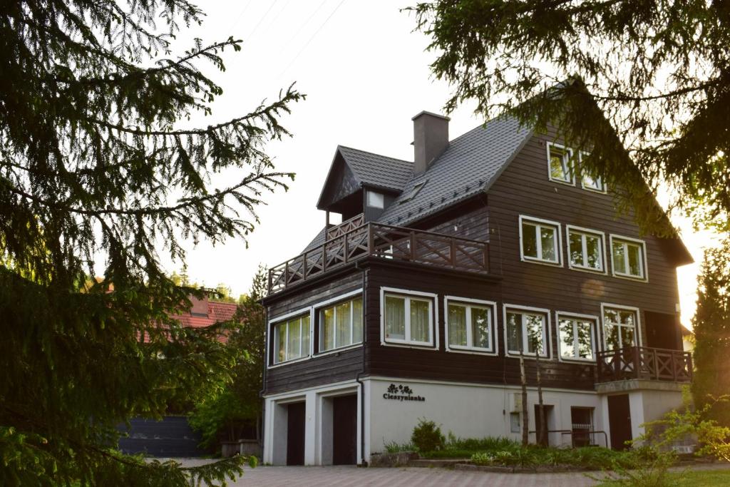 a large black and white house with windows at Willa Cieszynianka in Wisła