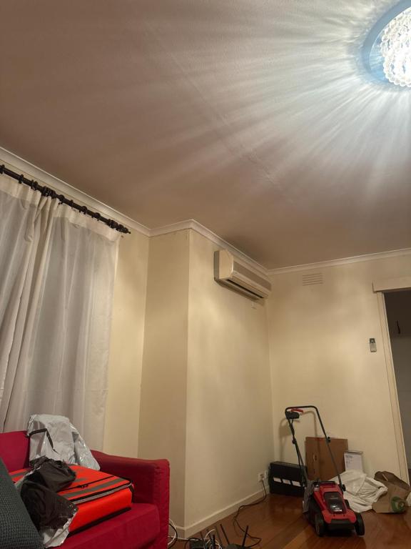 a living room with a red couch and a ceiling at Al amin in Bell Post Hill