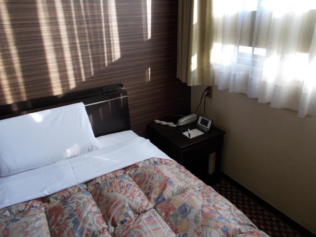 Postel nebo postele na pokoji v ubytování Hotel Matsuyama Hills