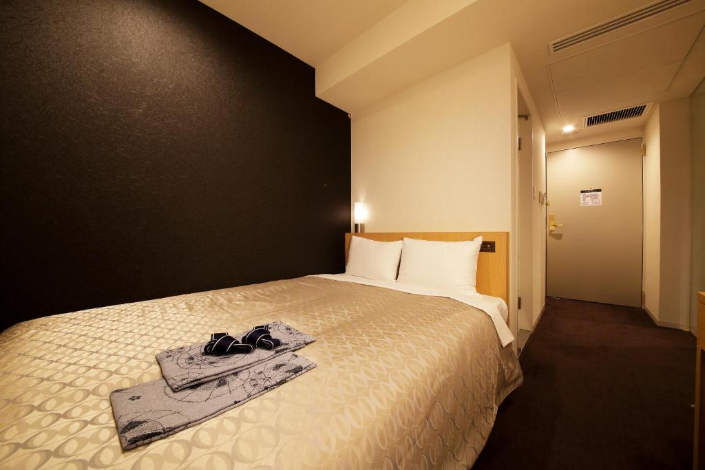 Postel nebo postele na pokoji v ubytování Hotel Asia Center of Japan