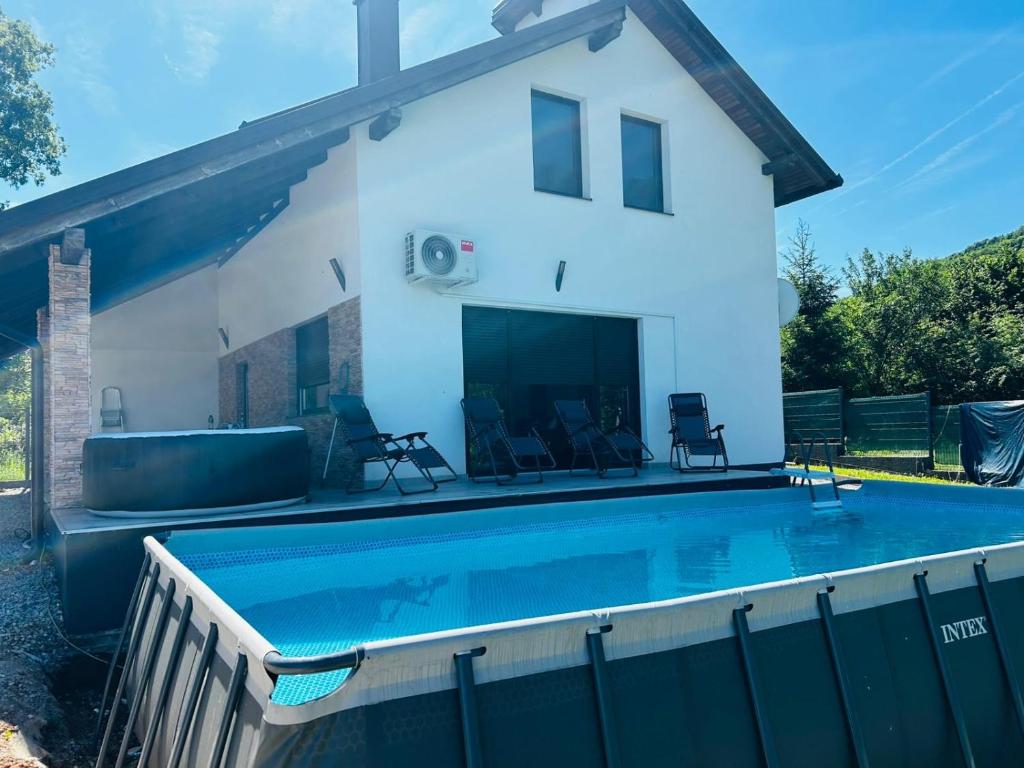 a swimming pool in front of a house at Lux apartmani in Bihać