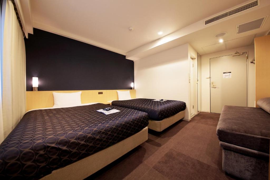 Postel nebo postele na pokoji v ubytování Hotel Asia Center of Japan