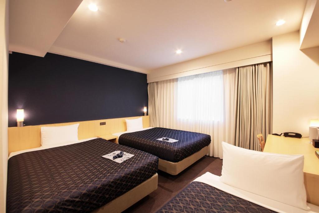 Postel nebo postele na pokoji v ubytování Hotel Asia Center of Japan