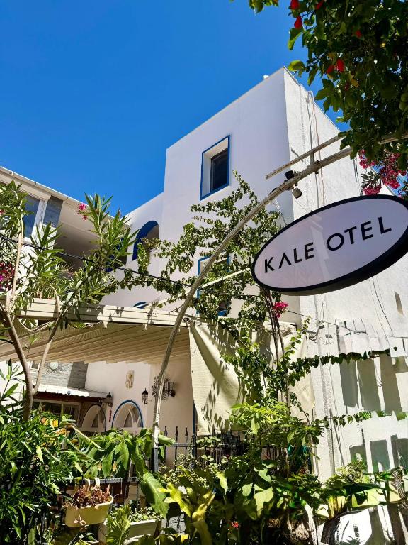 a sign in front of a building with a kale object at Kale Otel Bodrum in Bodrum City