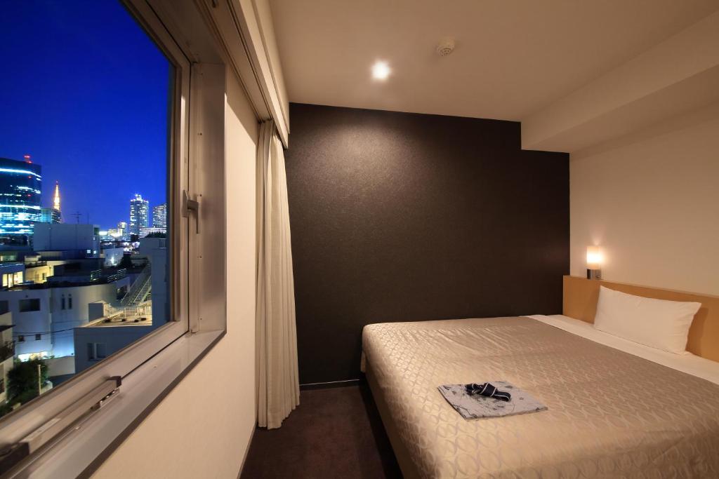 Postel nebo postele na pokoji v ubytování Hotel Asia Center of Japan