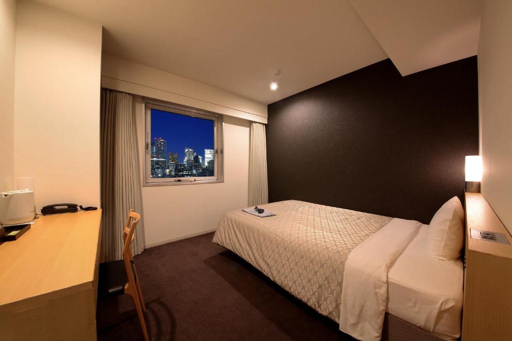 Postel nebo postele na pokoji v ubytování Hotel Asia Center of Japan