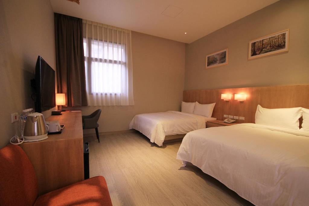 Postel nebo postele na pokoji v ubytování Hangkhau Hotel