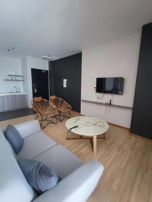 a living room with a couch and a coffee table at family 1 bed room apartment in Malacca