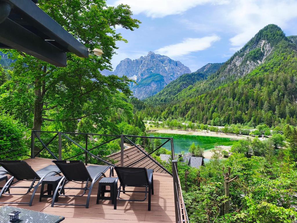 a balcony with a table and chairs overlooking a river at Apartments Smolej Kranjska Gora in Kranjska Gora
