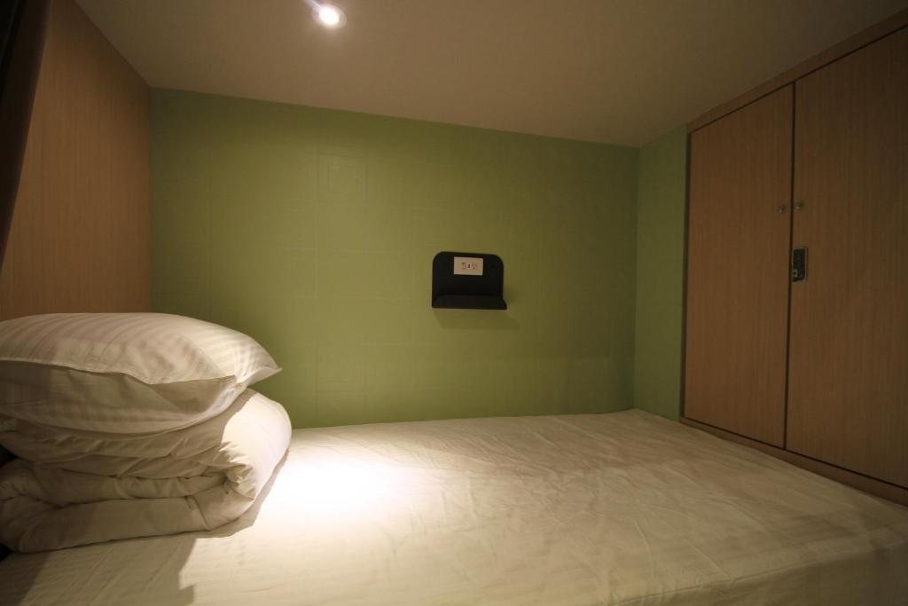 Postel nebo postele na pokoji v ubytování Hangkhau Hotel