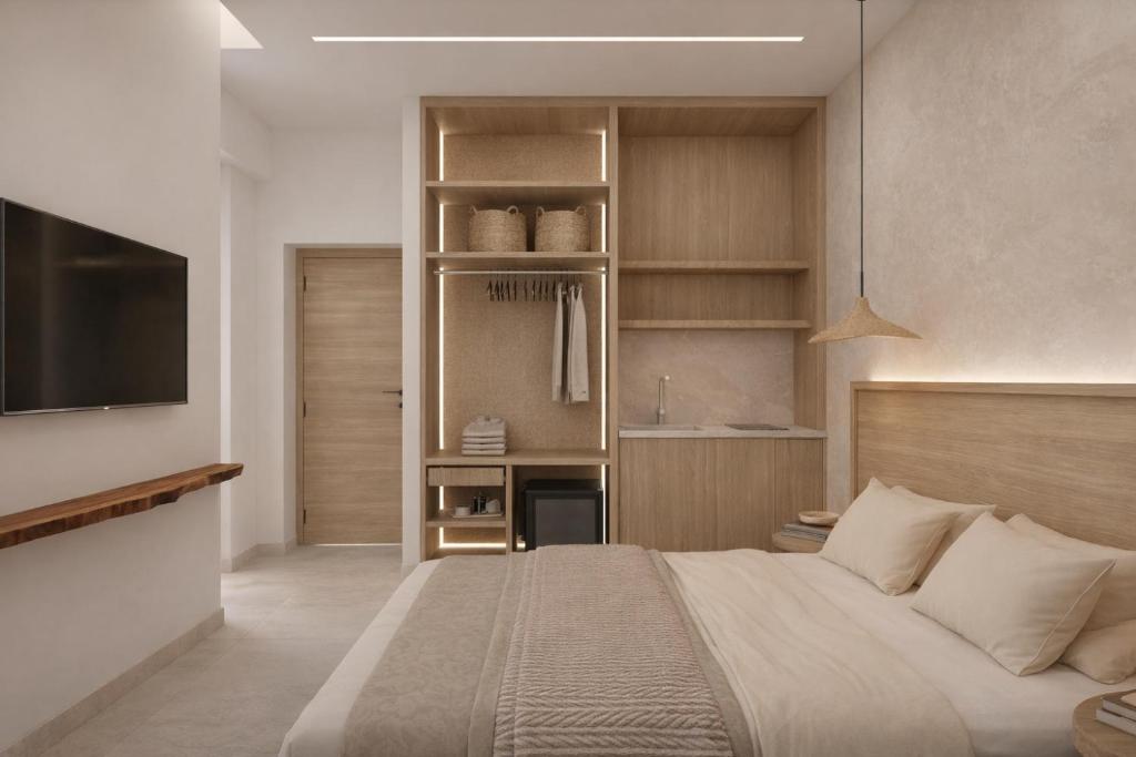 a bedroom with a large bed and a tv at Theera by Premium Key in Skiathos