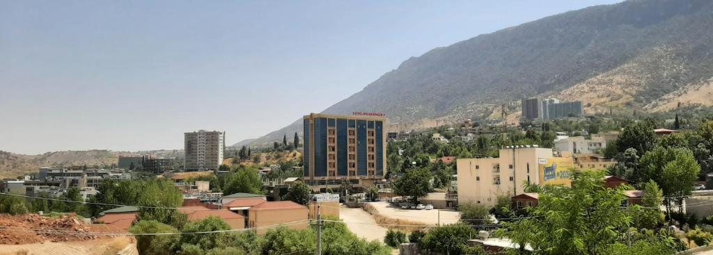 a view of a city with mountains in the background at modern sity hotel in Erbil