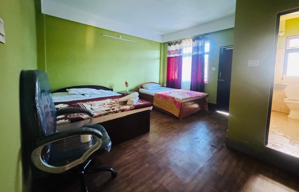 a bedroom with a desk and a chair in a room at The Mirik Address in Mirik