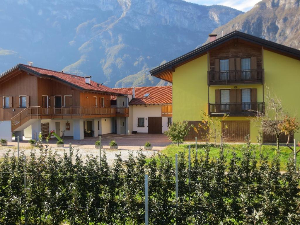 a row of houses with mountains in the background at Agritur Clementi in Nave San Rocco