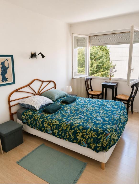 a bedroom with a bed and a table and a window at Chambre privée, ANGLET, quartier central in Anglet