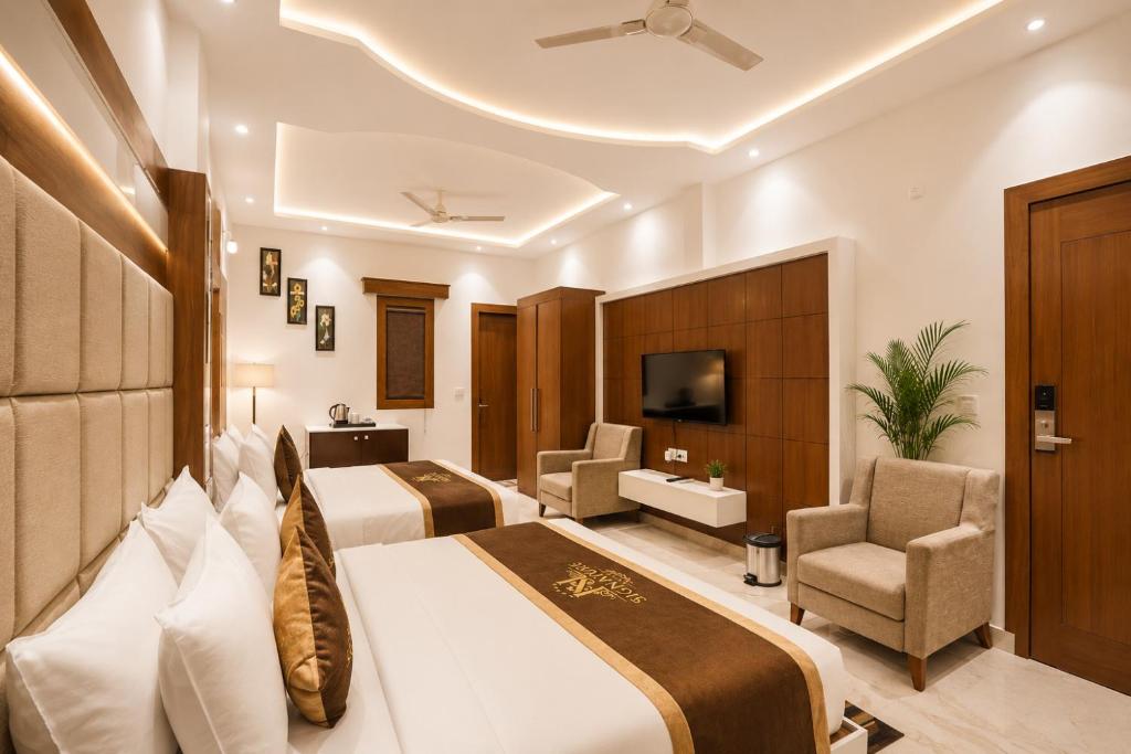 a hotel room with two beds and a tv at Taj View By Signature Stayz in Agra