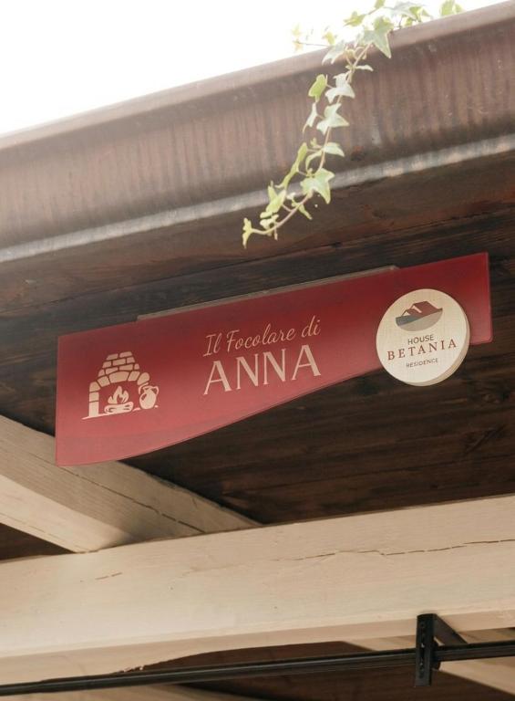 a sign hanging from the ceiling of a building at House Betania in San Ferdinando