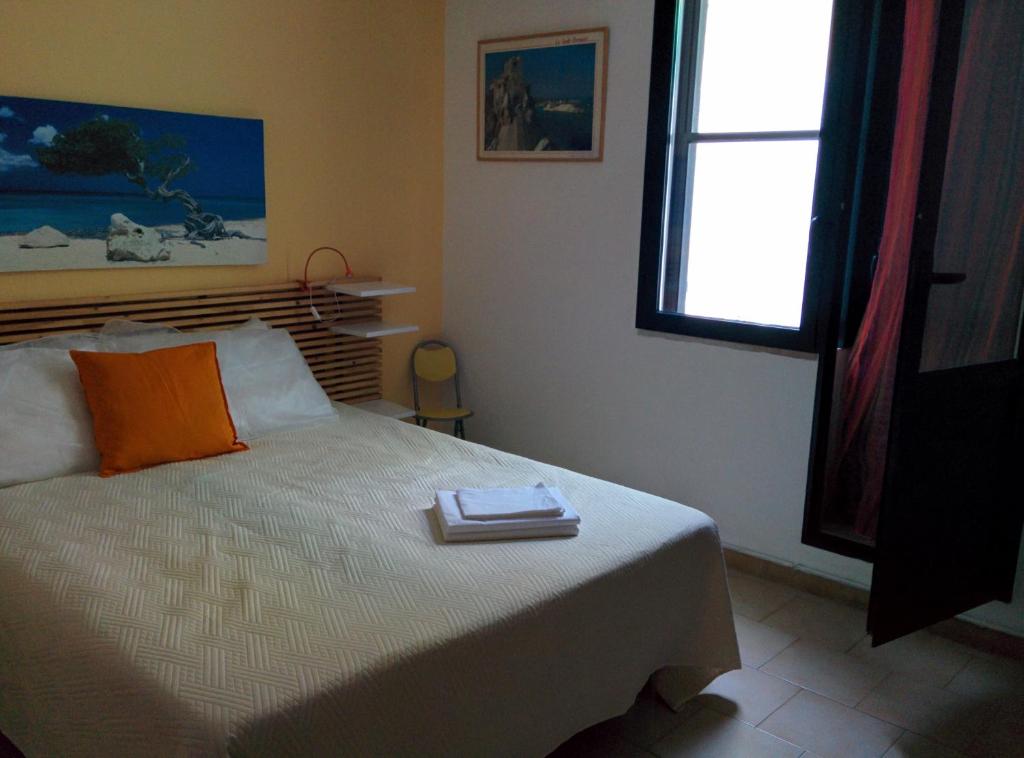 Postel nebo postele na pokoji v ubytování Residence Cala delle Arene