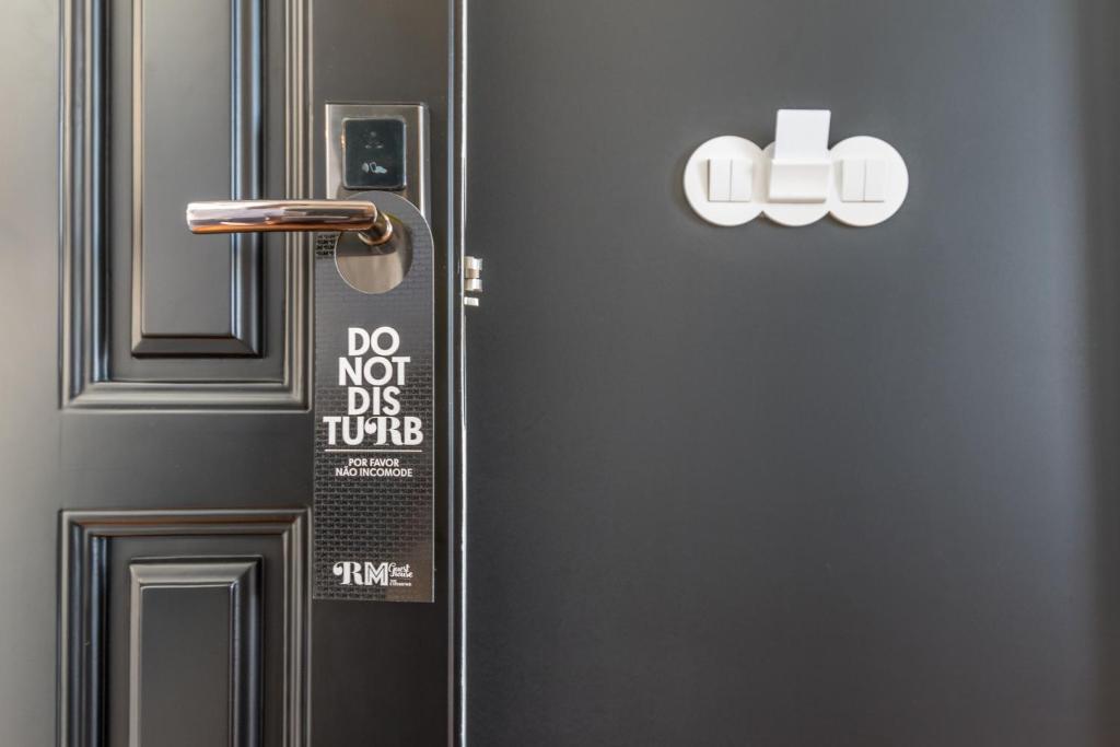 a refrigerator with a sign on the door of it at RM The Experience - Small Portuguese Hotels in Setúbal