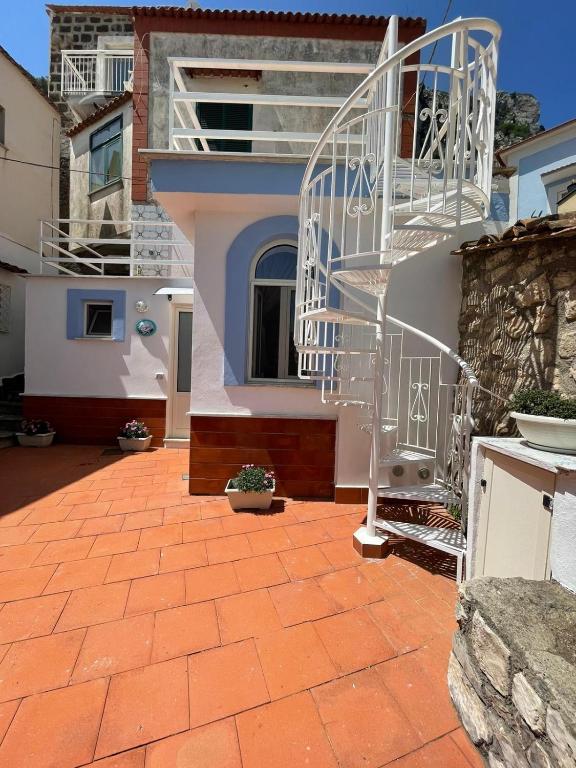 a house with a staircase in front of a building at L'Angolo Vacation Home in Nerano
